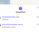 The main focus of the image is the StreetPass app interface, which displays user accounts in the fediverse.